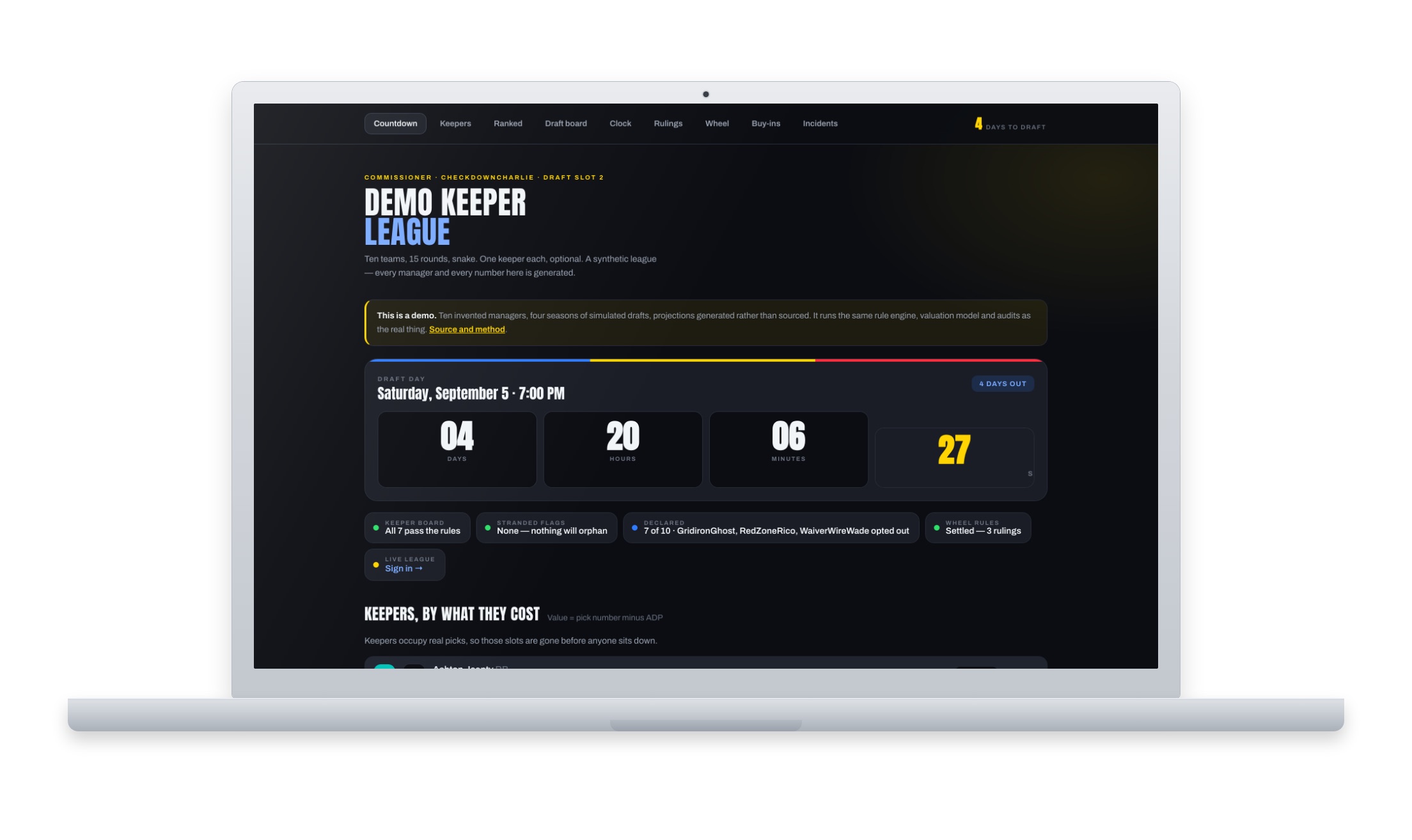 Laptop showing a dark fantasy football keeper dashboard, with a draft countdown clock and league status cards